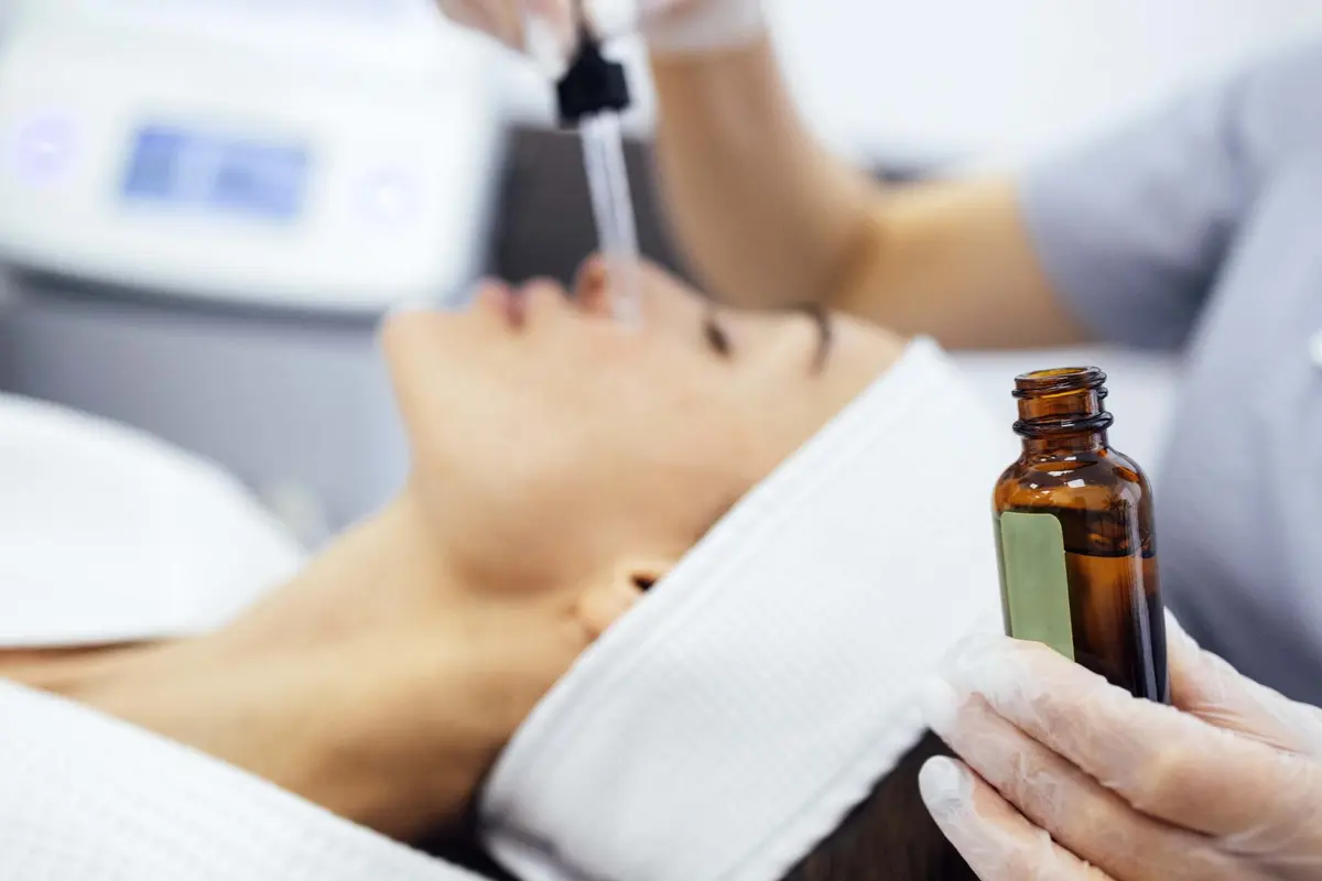 Beautician applying skin booster serum from a pipette at Inga's Secrets Aesthetics Northampton