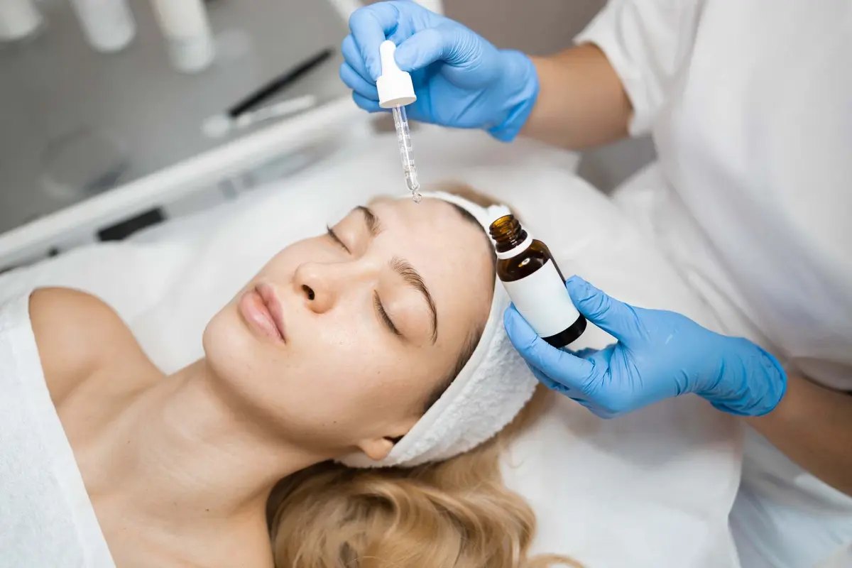 Cosmetologist applying nourishing serum to the face at Inga's Secrets Aesthetics Northampton